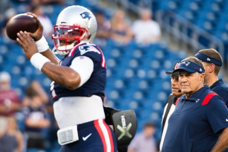 Patriots head coach Bill Belichick watches Cam Newton, who has been cut, warm up