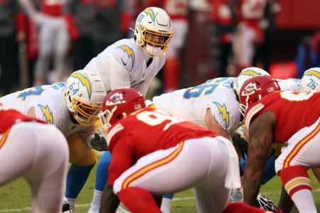 QB Justin Herbert takes the snap against the Kansas City Chiefs at Arrowhead Stadium