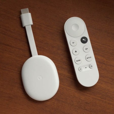 Chromecast with Google TV device and remote, sitting on a table. Our review praises the organization the service brings to streaming