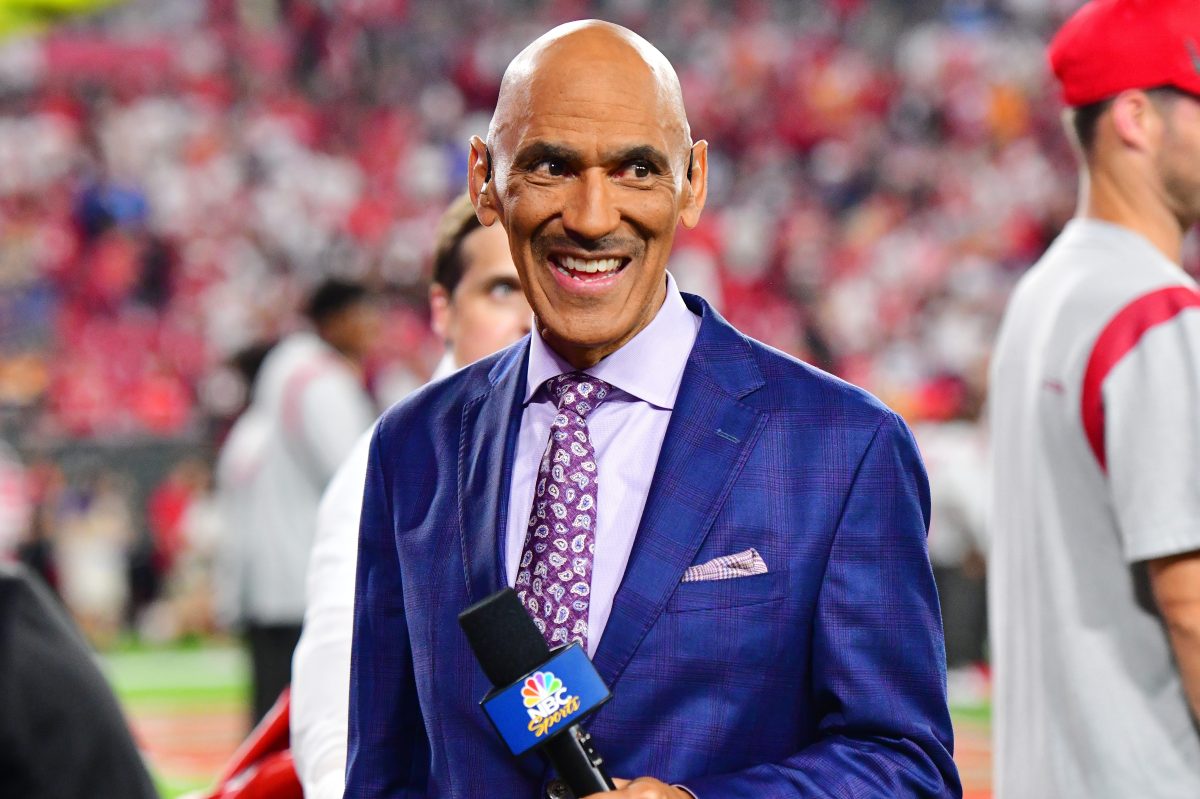 Tony Dungy holding a microphone prior to the NFL opener between the Tampa Bay Buccaneers and the Dallas Cowboys