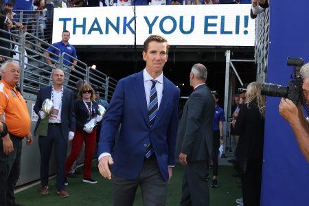 Eli Manning walks onto the field during his ring of honor induction ceremony