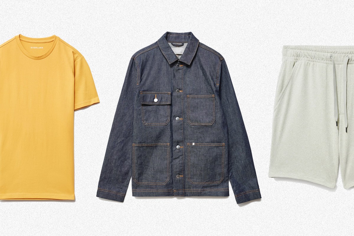 A yellow T-shirt, denim chore jacket and light green lounge shorts from Everlane on a grey background