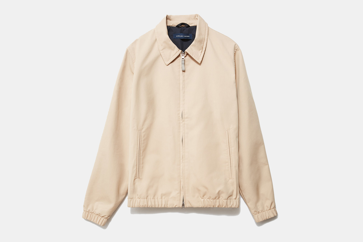 The Everyday Jacket from Everlane in khaki on a grey background