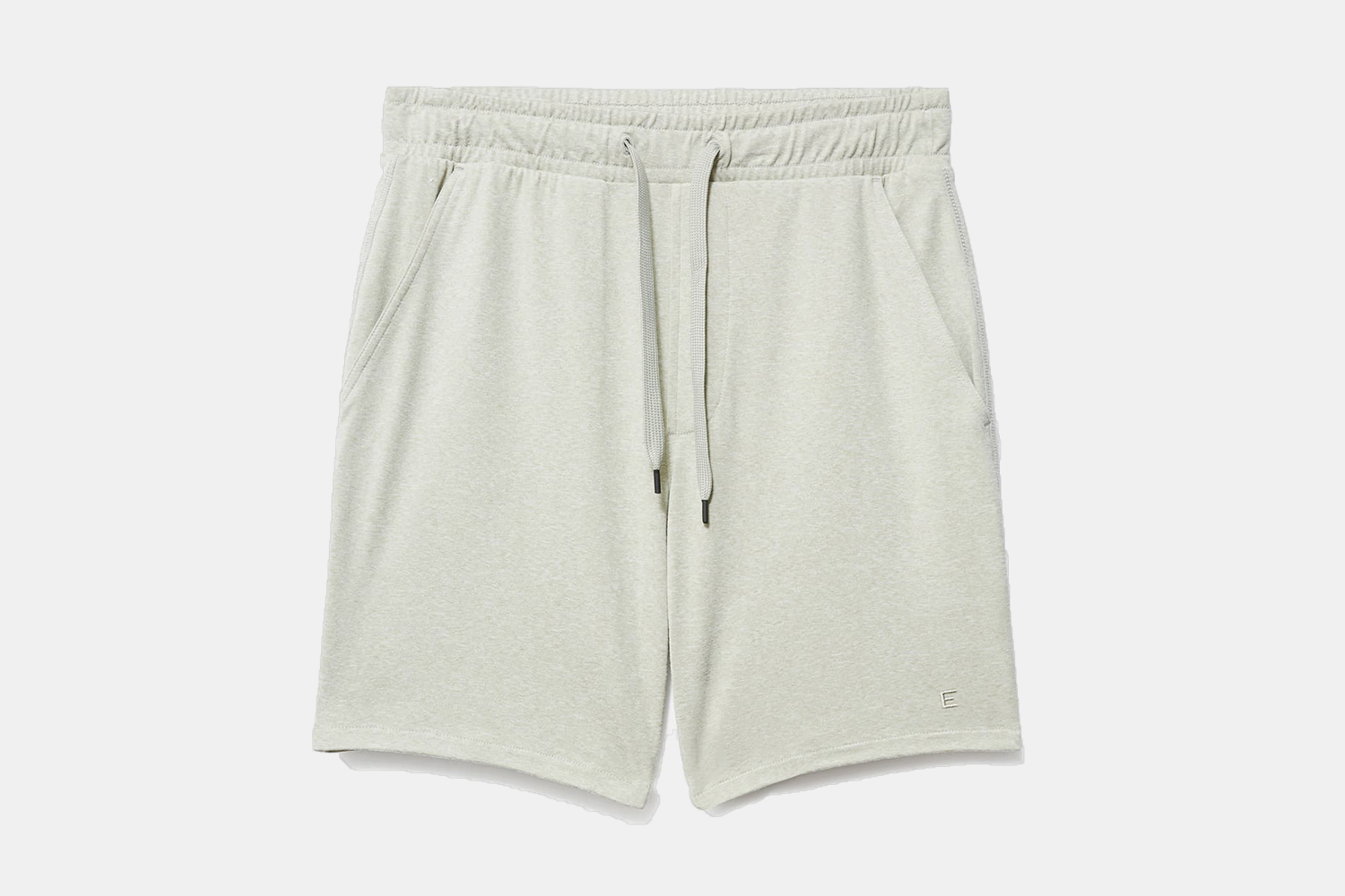 A pair of Everlane's men's ReNew Air Shorts in light green on a grey background