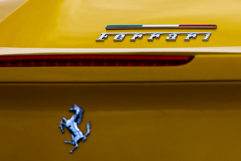 The words "Ferrari" and the luxury car brand's Prancing Horse logo on a yellow car