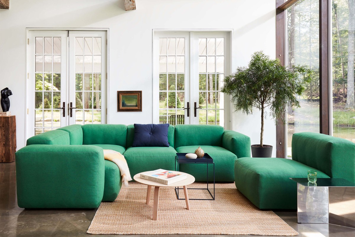 A Mags Soft Low Sectional Sofa from Hay Design in green as the centerpiece in a well-lit living room