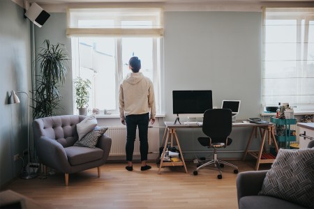 A remote worker takes a break to stare out the window.