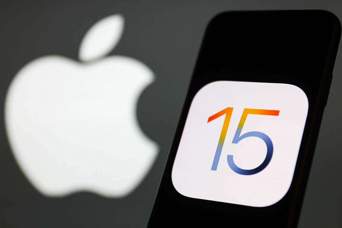 A photo illustration of Apple iOS 15, which has new privacy features, showing an iPhone with the number 15 and the Apple logo in the background