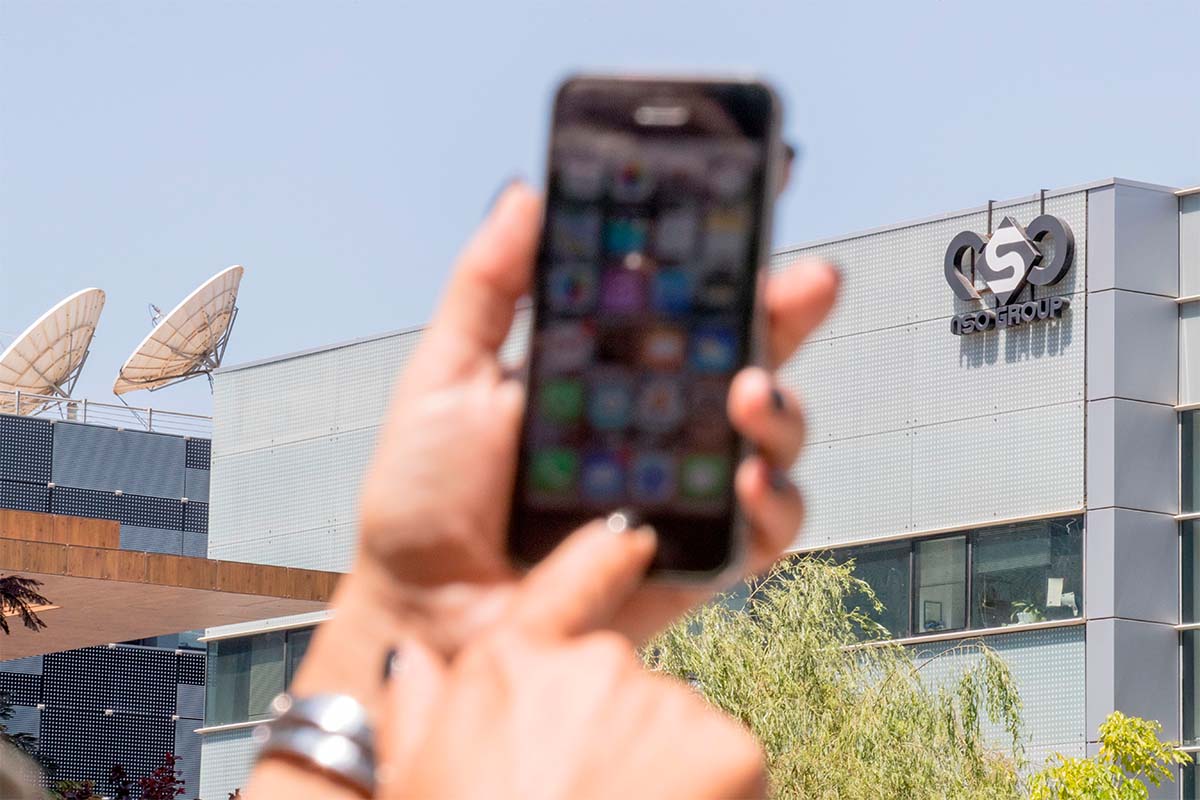 An Israeli woman uses her iPhone in front of the building housing the Israeli NSO group, on August 28, 2016, in Herzliya, near Tel Aviv. NSO's spyware has been an issue for Apple since 2016.