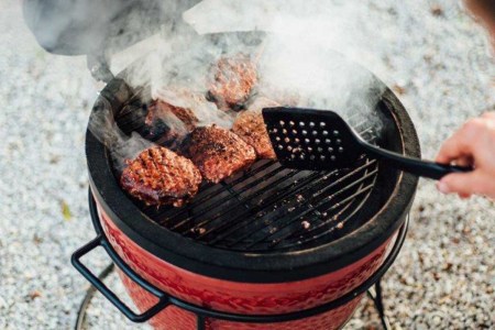 cooking burgers on a Kamado Joe Jr. 13.5 inch Charcoal Grill in Blaze Red, now on sale at Walmart