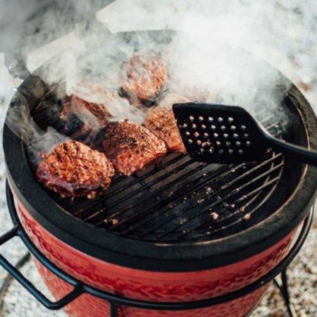 cooking burgers on a Kamado Joe Jr. 13.5 inch Charcoal Grill in Blaze Red, now on sale at Walmart