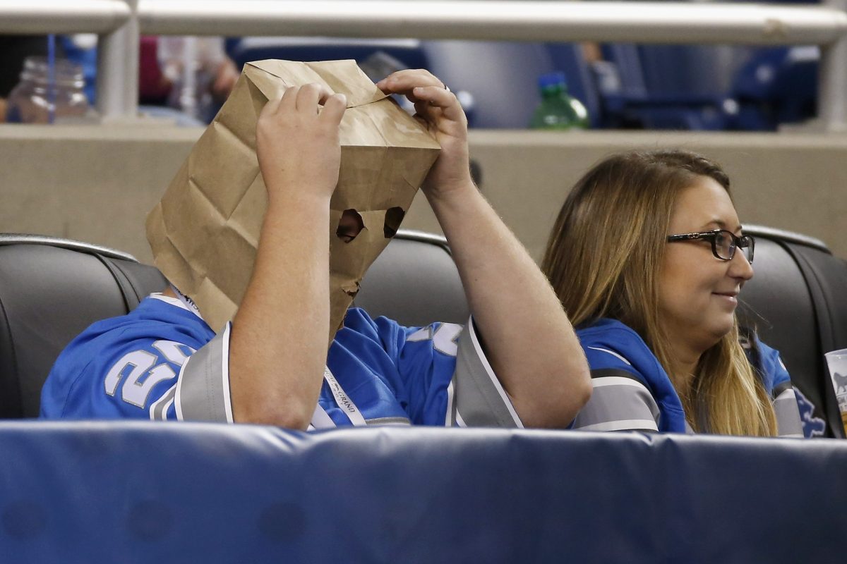 A Detroit Lions fan looks on with a paper bag on his head during a 2015 game