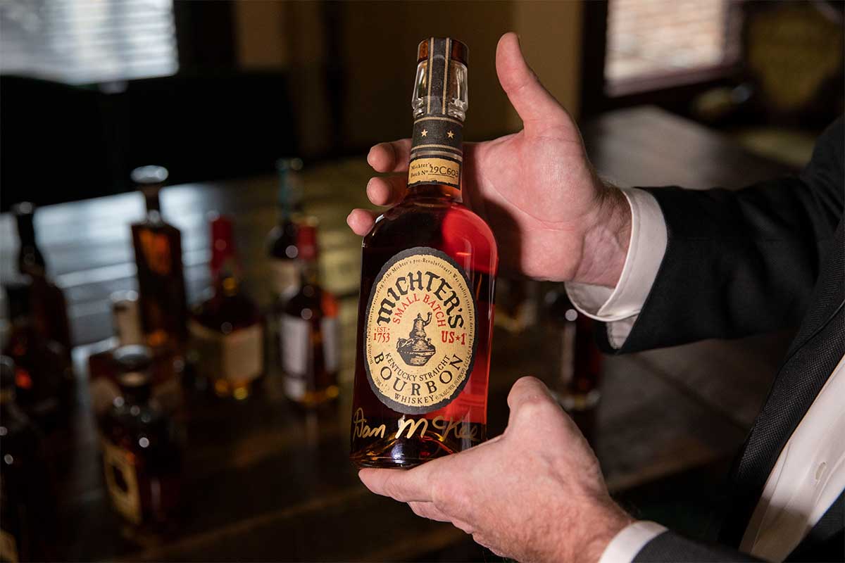 Eric Gregory, president of the Kentucky Distillers' Association, shows a bottle of Kentucky bourbon whiskey as he receives an interview with Xinhua at his office in Frankfort, Kentucky, the United States, Nov. 26, 2019. Michter's is a Kentucky Straight Bourbon -- but there is some disagreement if 95% of bourbon is actually produced in Kentucky