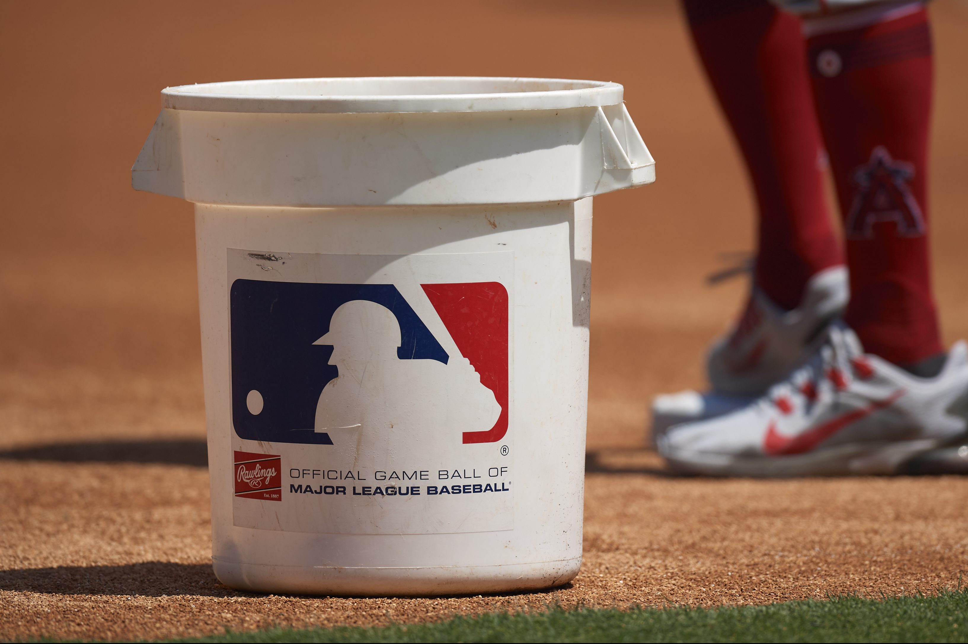 A bucket with the MLB logo on it on the field before a game