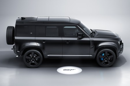 A side view of the all-black, limited-edition James Bond Land Rover Defender V8 inspired by "No Time to Die" and featuring 007 puddle lamps