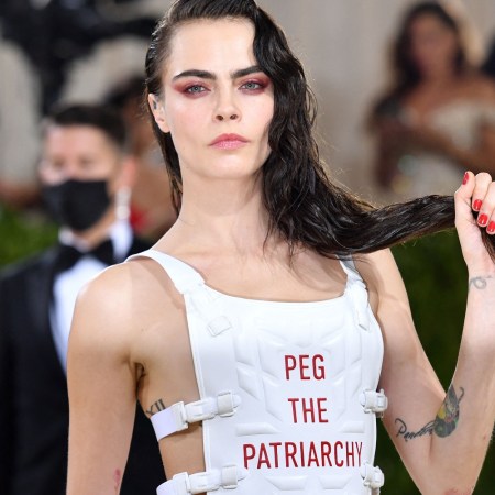Cara Delevingne wears a white vest with the words "Peg the Patriarchy" at the 2021 Met Gala.
