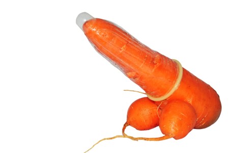 Photo shows a phallic carrot wearing a condom