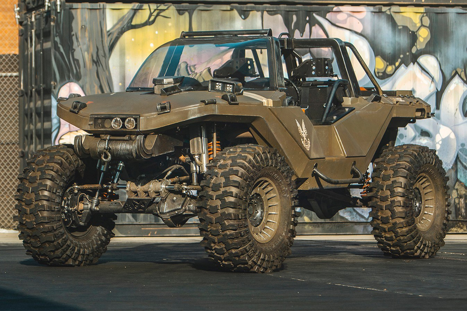 A real-life, working Warthog vehicle from the "Halo" video games sitting in a parking lot, designed and made by Ken Block's Hoonigan team