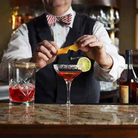 A bartender makes a cocktail at The Round Robin Bar at the Willard Intercontinental