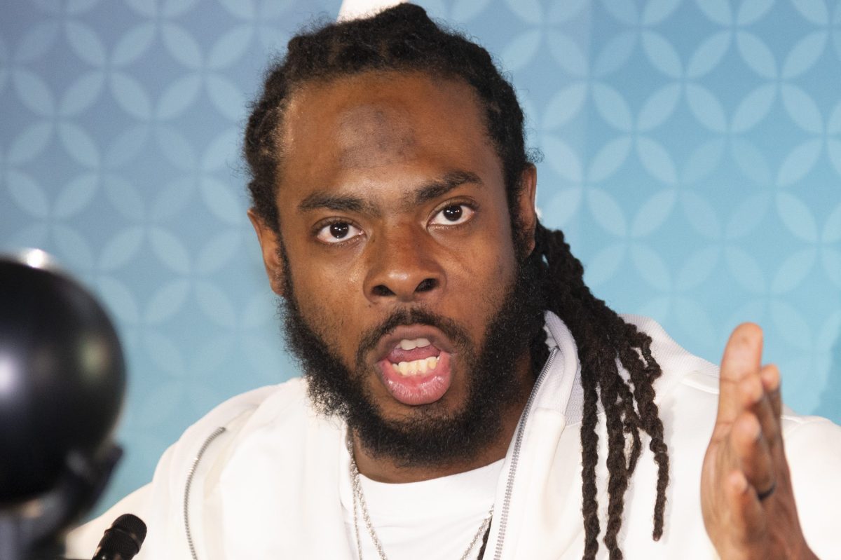 NFL cornerback Richard Sherman gestures as he speaks to the media at the Super Bowl in 2020