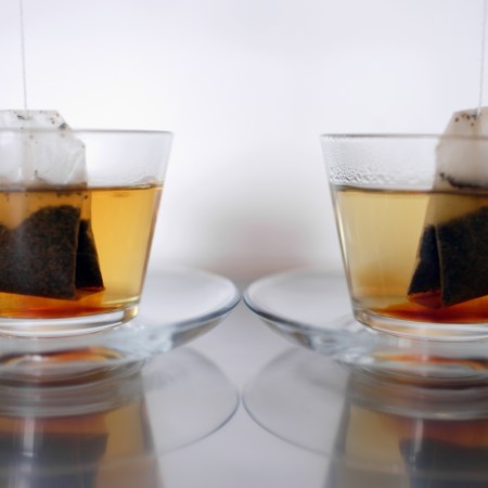 Image shows two tea bags steeping in clear mugs