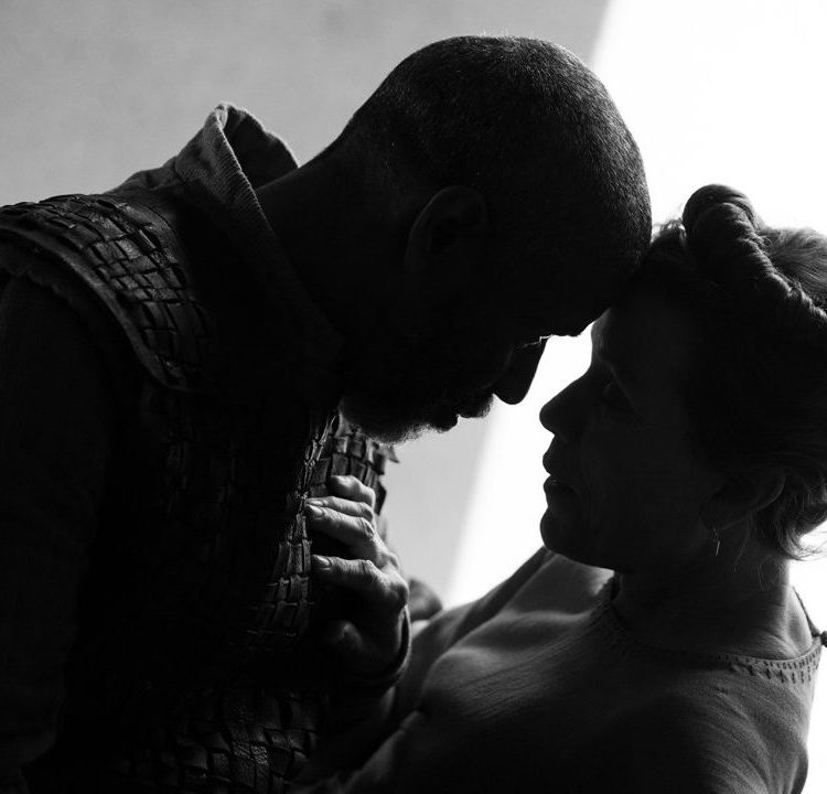 Denzel Washington and Frances McDormand touching heads in a scene from "The Tragedy of Macbeth," a black-and-white take on the Shakespearean tale from Joel Coen