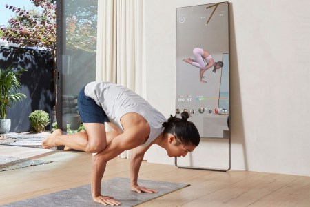A man doing exercises in front of the MIRROR.