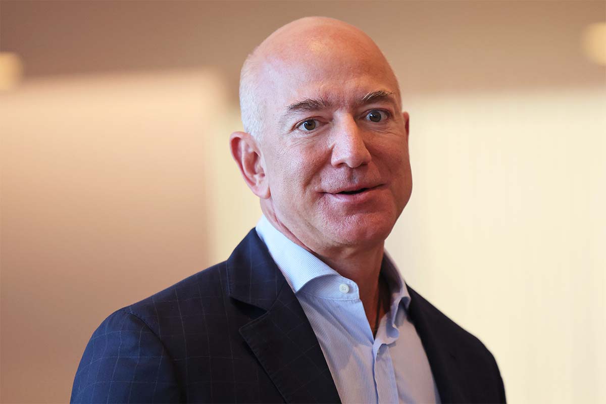 Jeff Bezos, who just topped the Forbes 400 list of wealthiest Americans, in a blazer and unbuttoned shirt