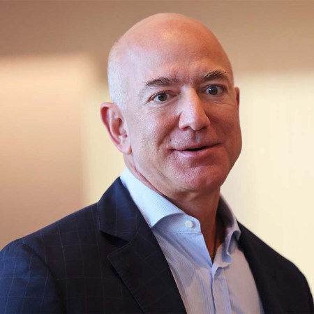 Jeff Bezos, who just topped the Forbes 400 list of wealthiest Americans, in a blazer and unbuttoned shirt