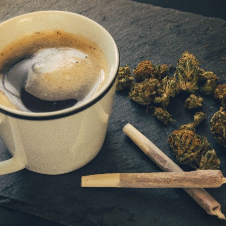 A cup of coffee, two joints and some loose cannabis. Weed and caffeine can work well together, according to some experts