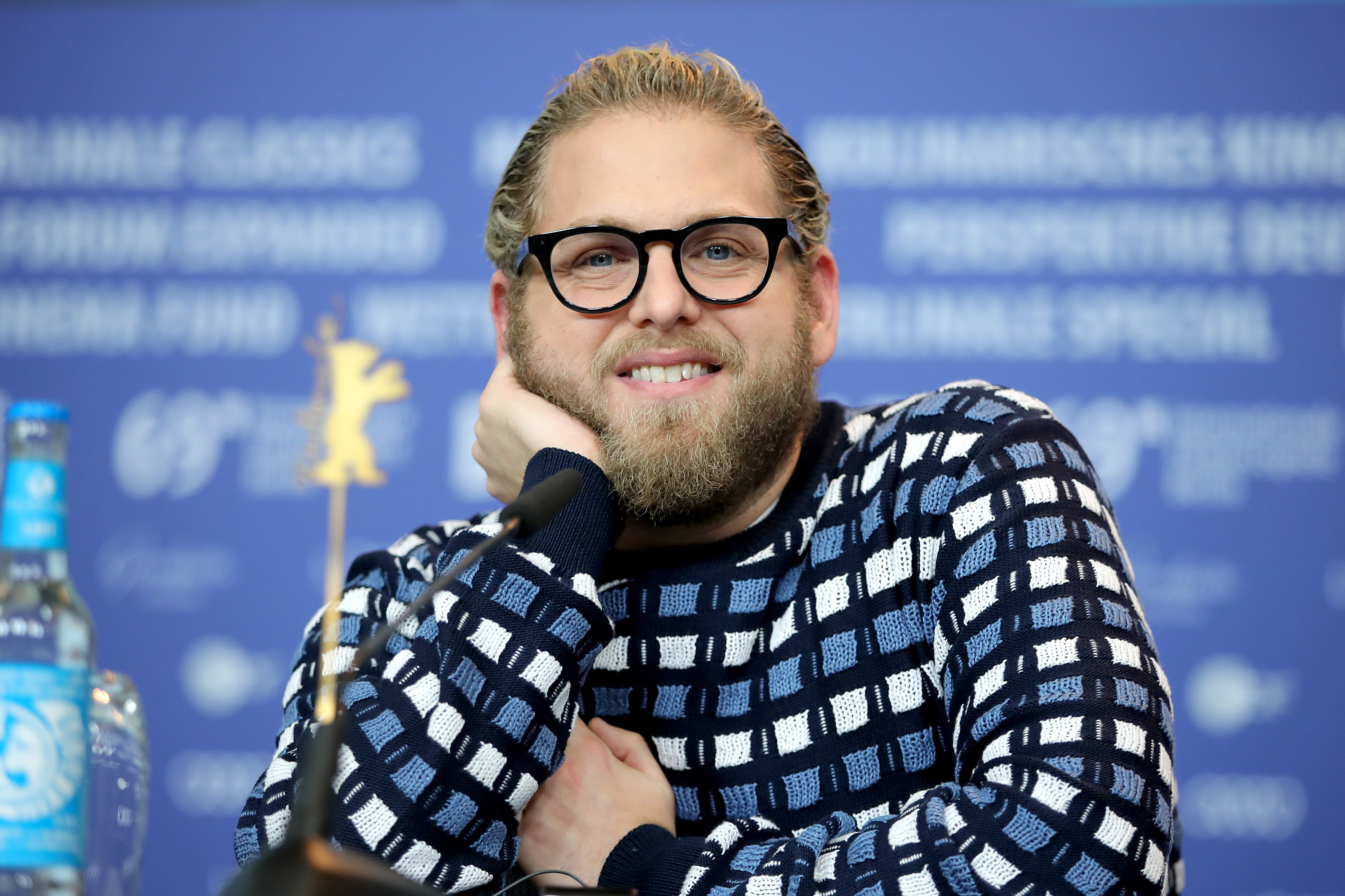 Actor Jonah Hill wearing glasses and a sweater during a press conference for his movie "Mid90s"