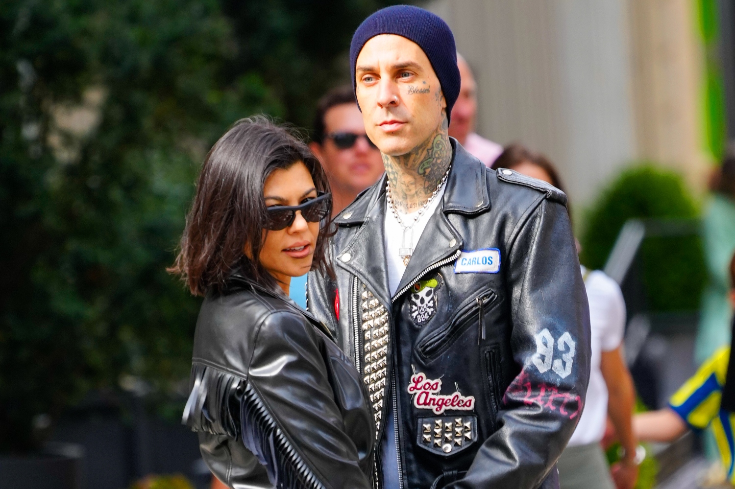 Travis Barker and Kourtney Kardashian embrace on the street in New York. Barker proposed to Kardashian with an oval engagement ring.