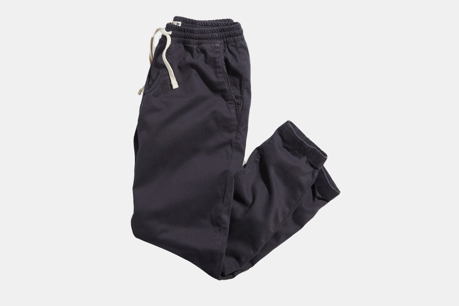 a pair of folded navy sweatpants 