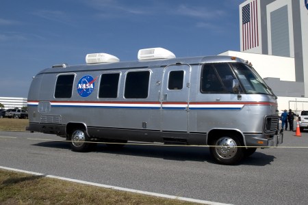 The NASA Astrovan, an Airstream motorhome outfitted to shuttle astronauts to the launch site, sitting still on a road