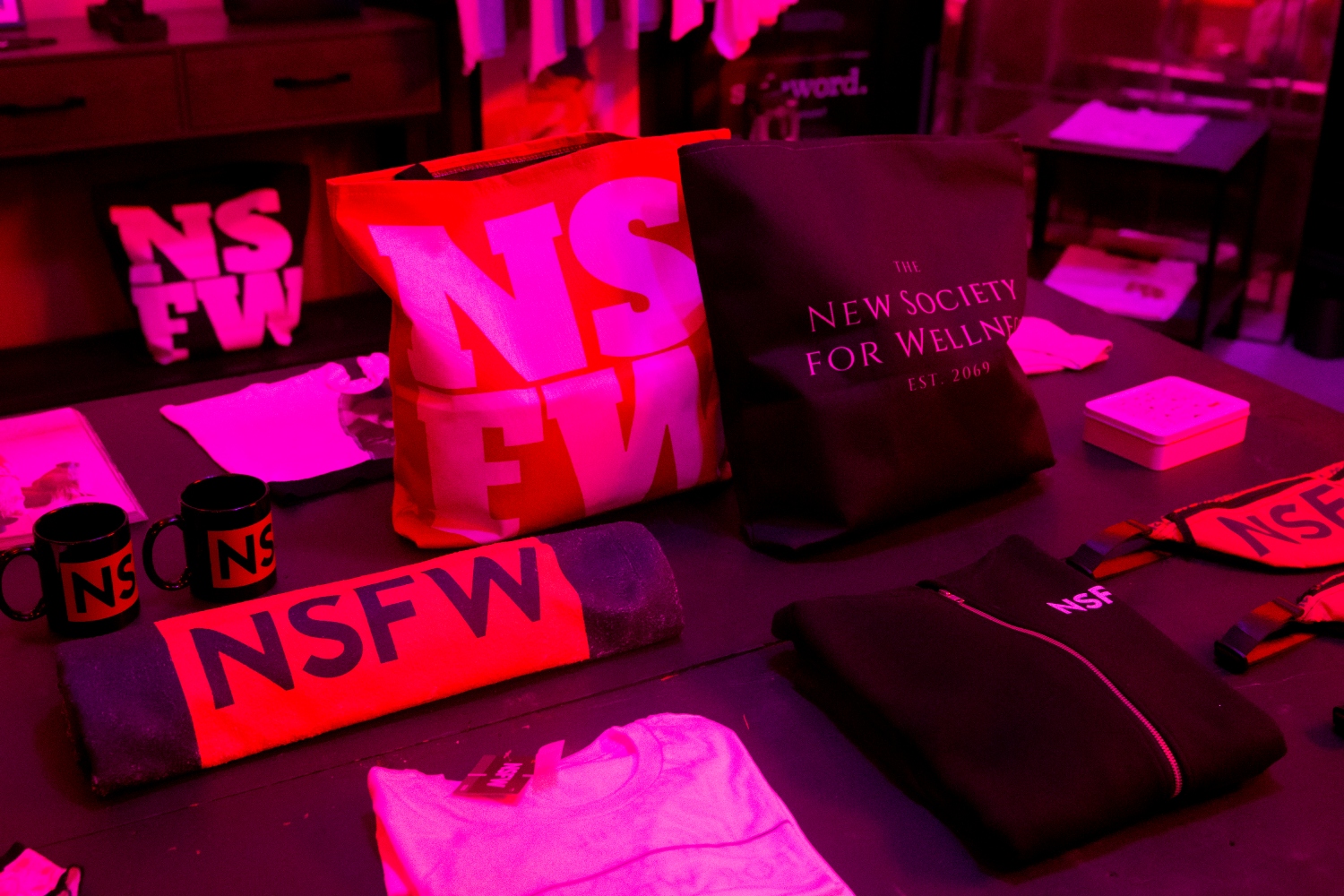 "NSFW" branded merchandise is laid out on a table