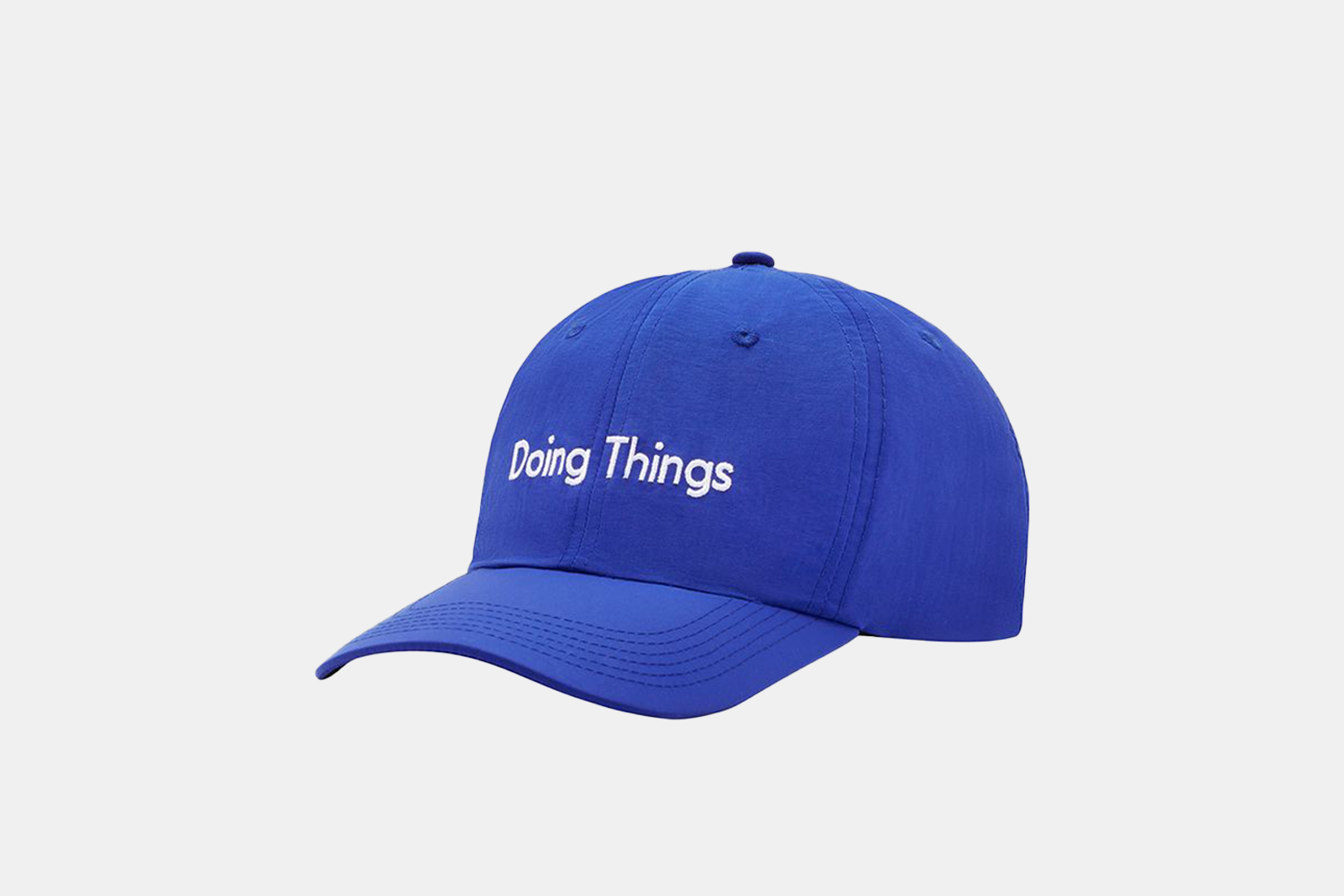 a light blue hat with the phrase "doing things" scrolled across the top.