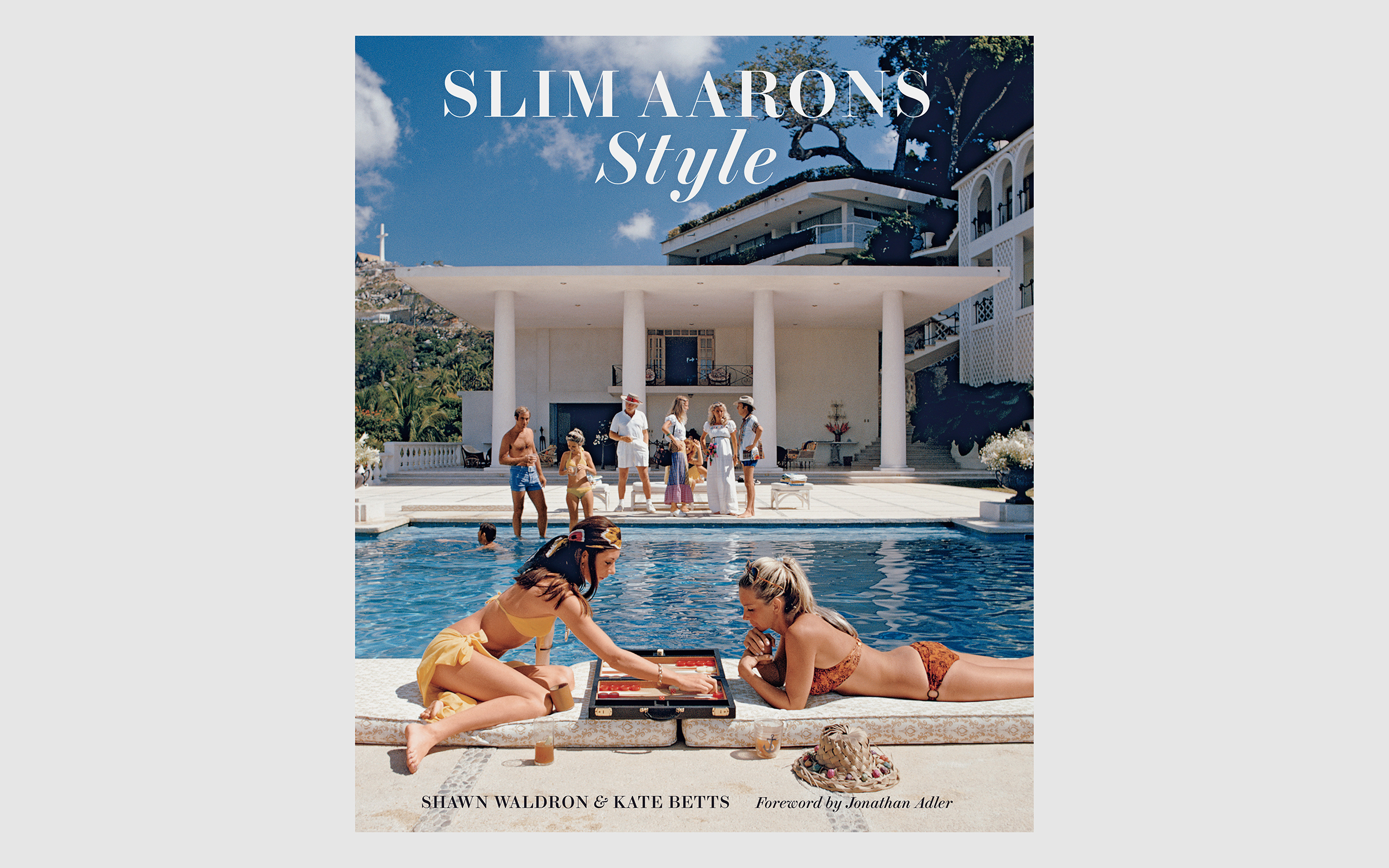 The cover of Slim Aarons: Style, the latest chapter of books featuring the lost world Aarons captured. It features women in bikinis lounging by a pool