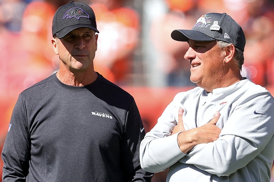 Baltimore Ravens coach John Harbaugh and Denver Broncos coach Vic Fangio chat. Fangio was angry about the Ravens final play call during Sunday's game.