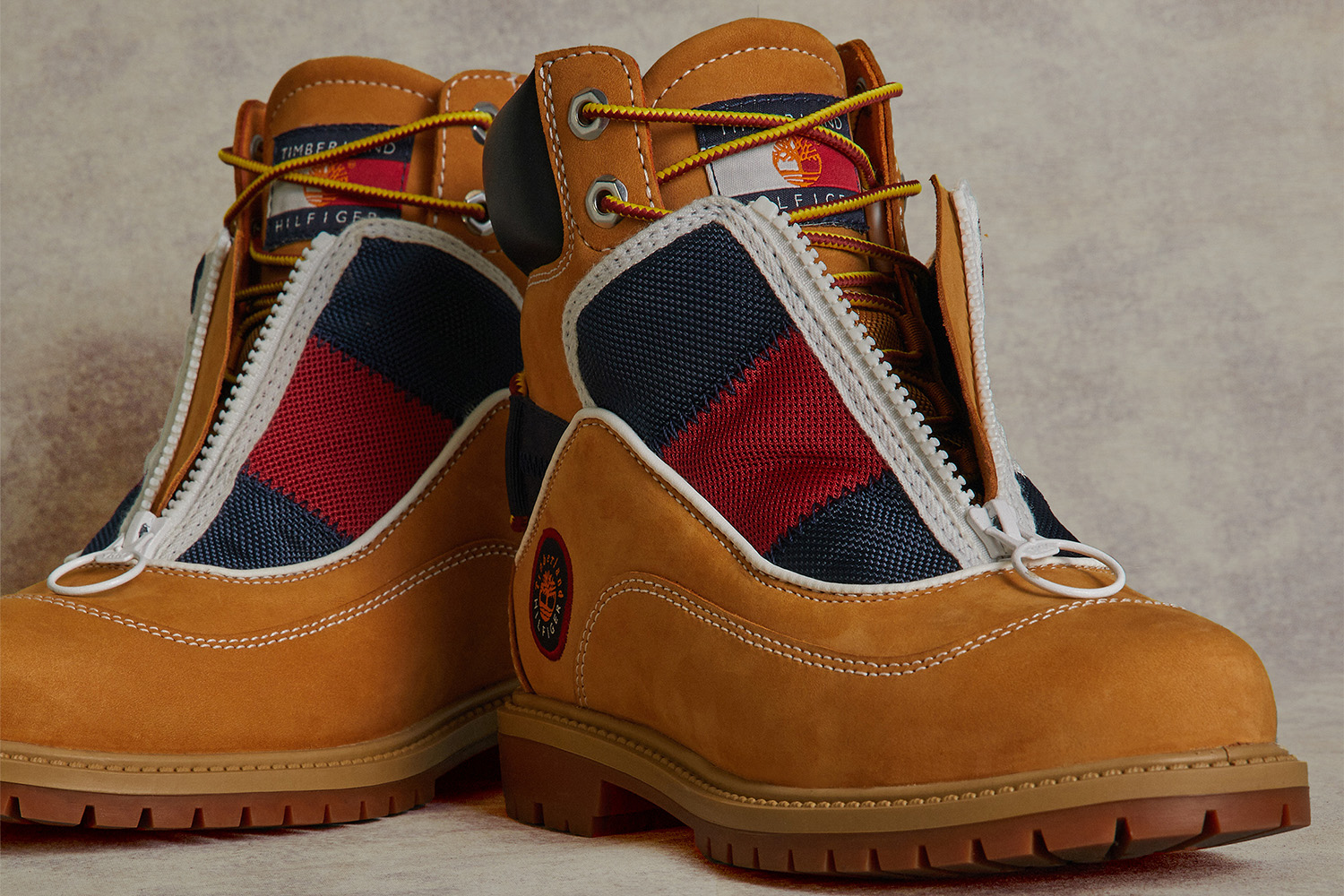 a classic timberland 6-inch wheat colored boot with Tommy Hilfiger detailing