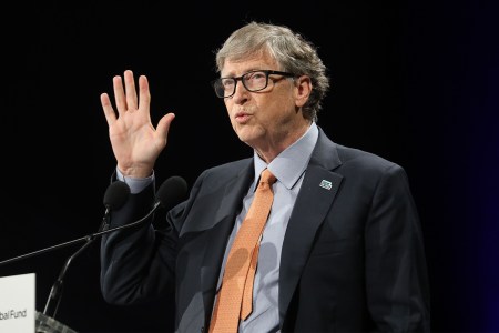 Bill Gates with a suit and tie at a lectern speaking in October 2019 in Lyon, France