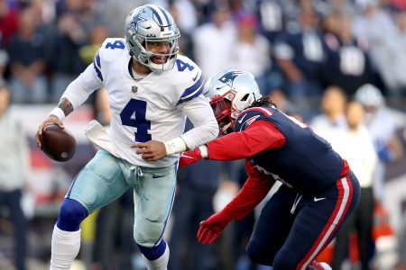Dak Prescott scrambles with the ball against the New England Patriots
