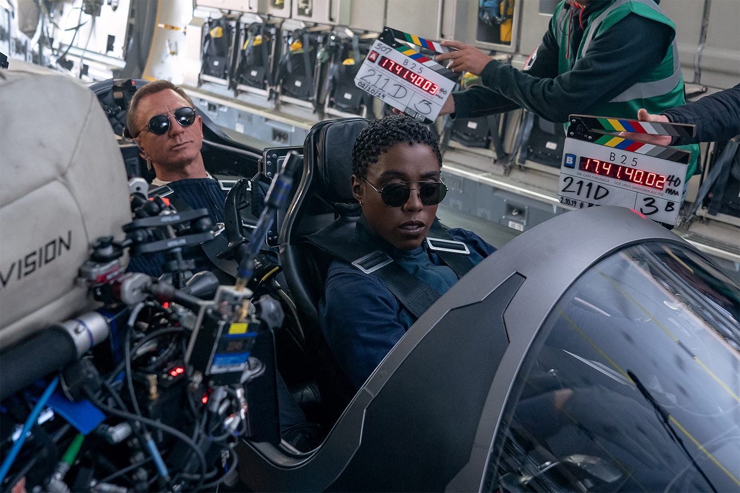 Daniel Craig (who plays James Bond) and co-star Lashana Lynch (who plays Nomi) with cameras pointed at them during the filming of a scene in "No Time to Die"