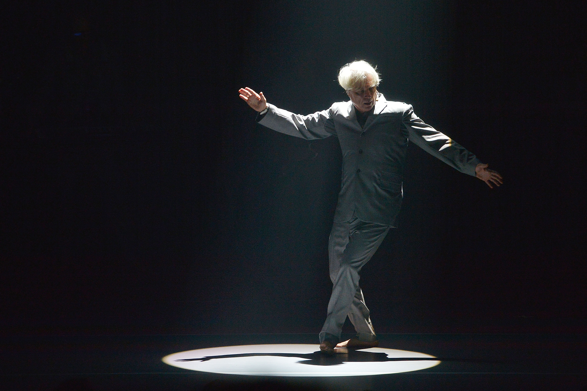 David Byrne performs live on stage during the first night of the European leg of his 'American Utopia' tour, at New Theatre on June 14, 2018 in Oxford, England.