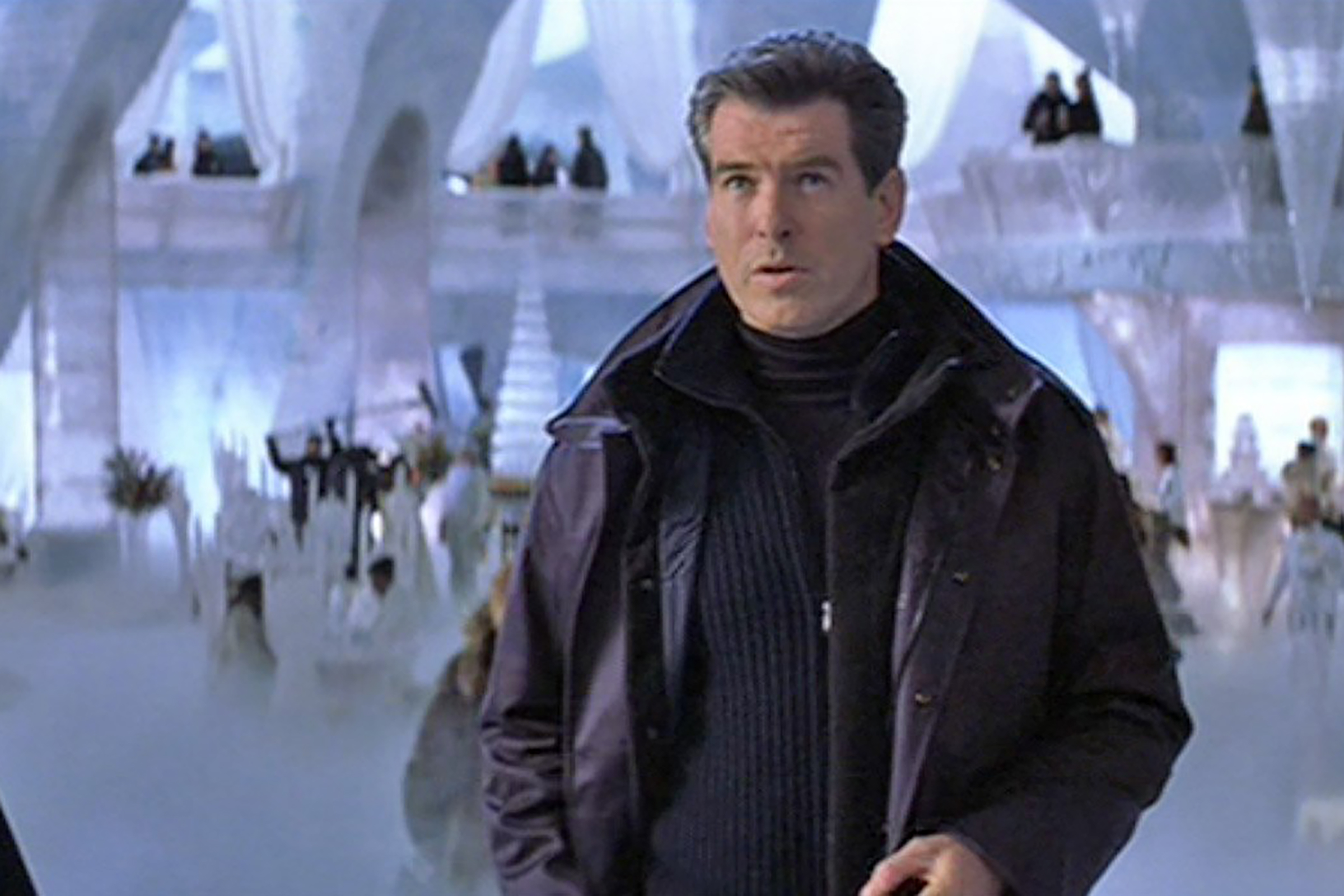 Brosnan layers a winter coat, a half zip sweater and a turtleneck in Die Another Day.