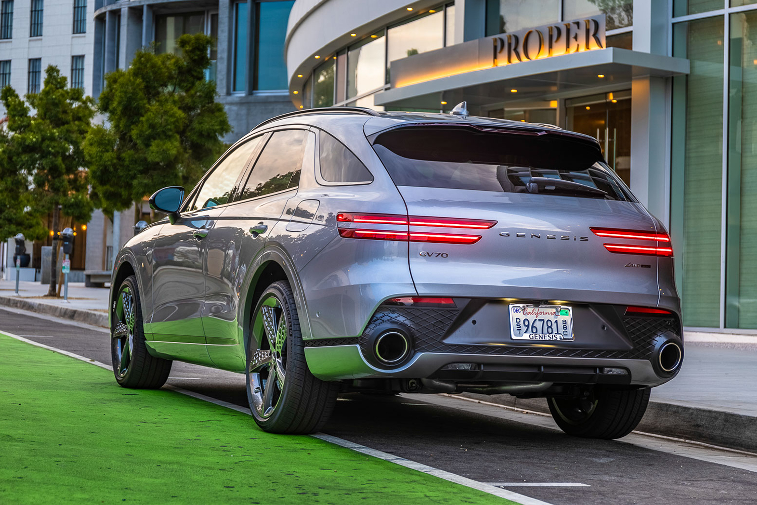 The back end of the new 2022 Genesis GV70 SUV, showing the taillights and exhaust pipes