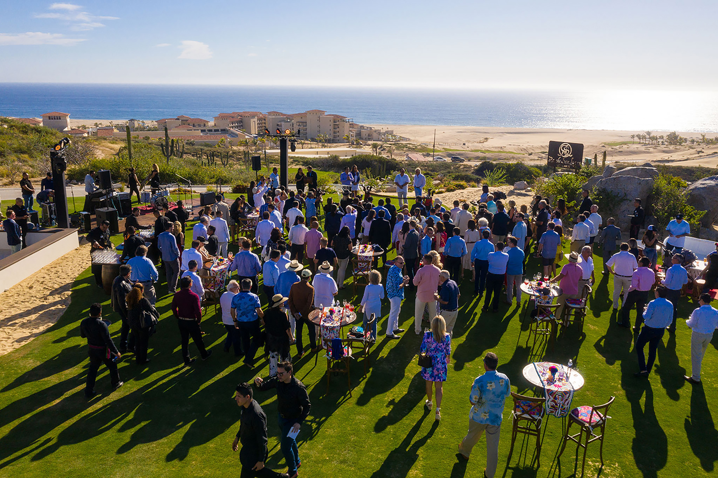 People gather at the opening of the Rancho San Lucas golf course overlooking the ocean.