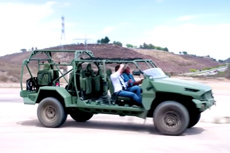 Jay Leno driving and GM Defense President Steve duMont riding in a military ISV version of the Chevy Colorado ZR2 off-road pickup truck