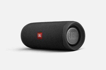 A black JBL Flip 5 Waterproof Portable Bluetooth Speaker on its side. The speaker is currently on sale at Woot.