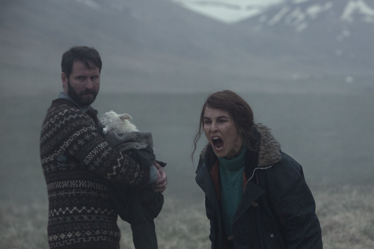 In a still from the Icelandic horror movie "Lamb," a mother screams while a father holds their hybrid lamb-human baby