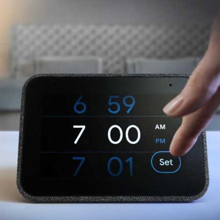 A person adjusting the time on a Lenovo Smart Clock, which is now on sale at Best Buy's eBay store
